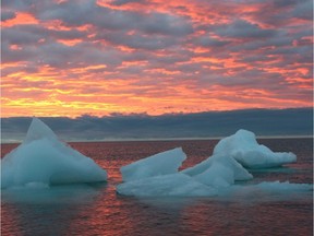 Ice chunks float in the Arctic Ocean as the sun sets near Barrow, Alaska.