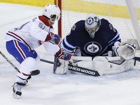 Winnipeg Jets goaltender Ondrej Pavelec (31) saves the shot by Montreal Canadiens' David Desharnais (51) during first period NHL action in Winnipeg on Thursday, March 26, 2015.