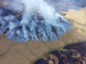 In this Sunday, June 7, 2015 file photo provided by the Alaska Division of Forestry, smoke rises from the Bogus Creek Fire, one of two fires burning in the Yukon Delta National Wildlife Refuge in southwest Alaska. Global warming is carving measurable changes into Alaska, and President Barack Obama is about to see it. President Obama leaves Monday, Aug. 31, 2015 for a three-day visit to the 49th state in which he will speak at a State Department climate change conference and become the first president to visit the Alaska Arctic. There and even in the sub-Arctic part of the state, he will see the damage caused by warming, damage that has been evident to scientists for years.  (Matt Snyder/Alaska Division of Forestry via AP, File )