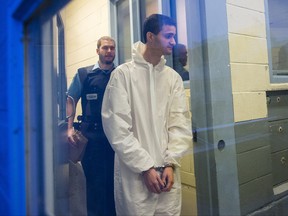 Patrick Levesque-Paquette is escorted into a prison vehicle as he leaves the St-Hyacinthe courthouse after his arraignment in St-Hyacinthe on Wednesday, December 2, 2015.