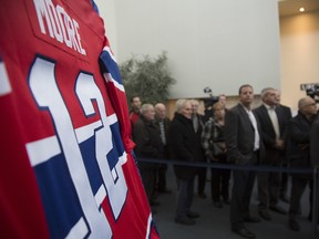 People come to pay their respects at the public visitation for late Canadiens legend Dickie Moore at Urgel Bourgie funeral home in Montreal on Sunday, Dec. 27, 2015.