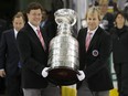 The Hockey Hall of Fame's Phil Pritchard (right) and Craig Campbell carry the Stanley Cup to centre ice after the Detroit Red Wings' 2008 victory over the Penguins in Pittsburgh.