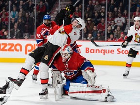 Ottawa Senators' Bobby Ryan falls over Canadiens goaltender Dustin Tokarski during the Habs' 3-1 win at the Bell Centre on Dec. 12, 2015.