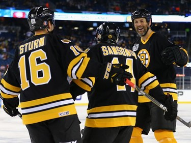 Hal Gill #75 of the Boston Bruins, right, and Rick Middleton #16, left congratulate Sergei Samsonov #14 after he scored against the Montreal Canadiens during the 2016 Bridgestone NHL Winter Classic  Alumni Game at Gillette Stadium on December 31, 2015 in Foxboro, Massachusetts.