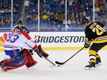 Mark Recchi #28 of the Boston Bruins takes a shot against Richard Sevigny #33 of the Montreal Canadiens during the 2016 Bridgestone NHL Winter Classic  Alumni Game at Gillette Stadium on December 31, 2015 in Foxboro, Massachusetts.