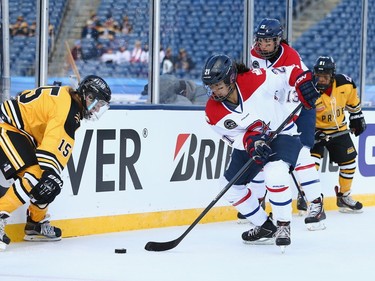 Julie Chu #21 of the Les Canadiennes (CWHL) skates against the Boston Pride (NWHL) during the Outdoor Womens Classic at Gillette Stadium on December 31, 2015 in Foxboro, Massachusetts.