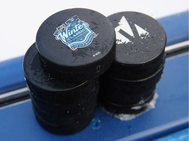 NHL Winter Classic pucks sit on the boards prior to the game between the Boston Pride (NWHL) and Les Canadiennes (CWHL) in the Outdoor Womens Classic at Gillette Stadium on December 31, 2015 in Foxboro, Massachusetts.