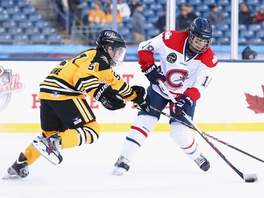 Kelly Cooke #5 of the Boston Pride (NWHL) defends against Katia Clement-Heydra #19 of the Les Canadiennes (CWHL) during the Outdoor Womens Classic at Gillette Stadium on December 31, 2015 in Foxboro, Massachusetts.