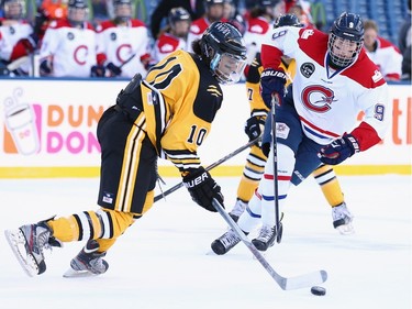 Blake Bolden #10 of the Boston Pride (NWHL) carries the puck against Kim Deschenes #9 of the Les Canadiennes (CWHL) during the Outdoor Womens Classic at Gillette Stadium on December 31, 2015 in Foxboro, Massachusetts.