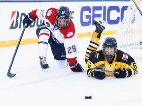Shannon Doyle #6 of the Boston Pride (NWHL) battles with Marie-Philip Poulin #29 of the Les Canadiennes (CWHL) during the Outdoor Womens Classic at Gillette Stadium on December 31, 2015 in Foxborough, Mass.