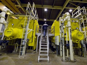 A city worker climbs onto the huge bank of racks that dry the sludge created as millions of litres of waste water are cleaned at the Montreal sewage treatment facility.