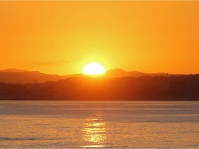 A fisherman casts the line during sunset, in Nice, southeastern France, Tuesday, Dec. 1, 2015. Temperatures in the area rose to 18 degrees Celsius (64 Fahrenheit).