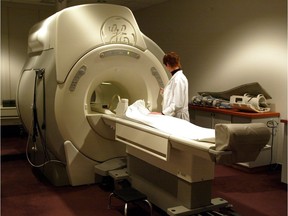 A technician operates an MRI machine at a private clinic in Calgary.