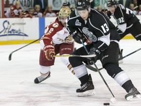 Acadie-Bathurst Titan’s Nicolas Dumulong, left, battling Gatineau Olympiques’ Alex Dostie, was taken to a hospital on Wednesday after his runaway car ran over his leg.