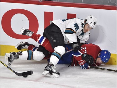 Montreal Canadiens' centre Alex Galchenyuk (27) is knocked to the ice by San Jose Sharks' right wing Barclay Goodrow (89) during first period NHL action, in Montreal, on Tuesday, Dec. 15, 2015