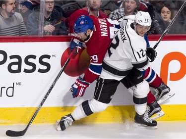Montreal Canadiens' Andrei Markov is checked into the boards by Los Angeles Kings' Marian Gaborik during second period NHL hockey action, in Montreal, on Thursday, Dec. 17, 2015.