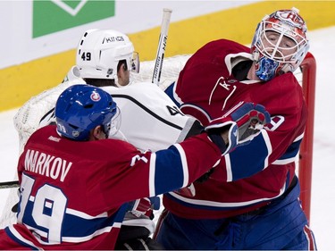 Los Angeles Kings' Michael Mersch (49) is sandwiched between Montreal Canadiens' goalie Mike Condon and his teammate Andrei Markov (79) during second period NHL hockey action, in Montreal, on Thursday, Dec. 17, 2015.