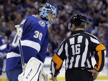 Tampa Bay Lightning goalie Ben Bishop (30) talks to referee Brian Pochmara (16) after the Montreal Canadiens were awarded a goal by Dale Weise during the third period of an NHL hockey game Monday, Dec. 28, 2015, in Tampa, Fla. The Lightning complained that Bishop was interfered with on the play.