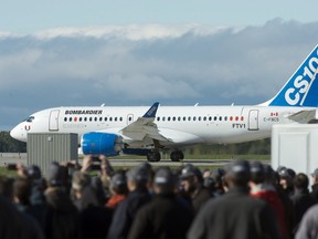 Bombardier's C-Series100 taxis to the runway during  its maiden test flight as employees and guests look on at the company's facility on Monday, Sept. 16, 2013 in Mirabel.