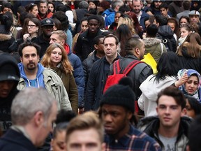 Shoppers walk through crowds on Oxford Street during the Boxing Day sales on December 26, 2015 in London, England.