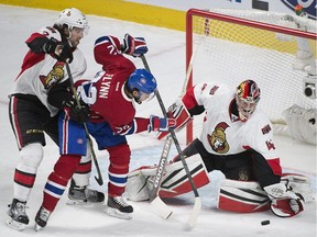 Montreal Canadiens' Brian Flynn (32) moves in on Ottawa Senators' goalie Craig Anderson as his teammate Jared Cowen (2) defends during second period NHL hockey action, in Montreal, on Saturday, Dec. 12, 2015.