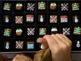 Members of the icing team decorate by hand festive biscuits and cakes at the Biscuiteers biscuit company in south London on December 8, 2015. The company has so far used 13,500kg of dough, 30,000 icing bags and 7,225kg of icing fulfilling Christmas orders.