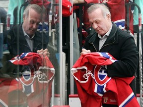"They get to the red line and they dump it in. It's a chasing game — all the time," says Canadiens great Guy Lafleur, signing jerseys, hats and cards for an endless stream of autograph seekers before the Habs Alumni Tour game in Calgary on Dec. 3, 2015, in Calgary. (Ted Rhodes/Calgary Herald)