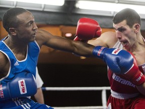 Kingsley Alexander, left, of Ontario, trades blows with Clovis Drolet, of Quebec, during their 75kg bout at the Canadian Olympic boxing trials, in Montreal, on Wednesday, Dec. 9, 2015.