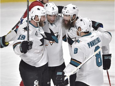 San Jose Sharks' right wing Dainius Zubrus (9) celebrates with teammates Joe Thornton, left, Brent Burns and Joe Pavelski, right, after scoring the third goal against the Montreal Canadiens during second period NHL hockey action, in Montreal, on Tuesday, Dec. 15, 2015.