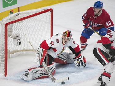 Ottawa Senators' goaltender Craig Anderson makes a save on Montreal Canadiens' Daniel Carr (43) during first period NHL hockey action, in Montreal, on Saturday, Dec. 12, 2015.
