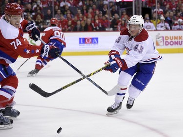 Montreal Canadiens left wing Daniel Carr (43) vies for the puck against Washington Capitals defenseman John Carlson (74) during the second period of an NHL hockey game, Saturday, Dec. 26, 2015, in Washington.