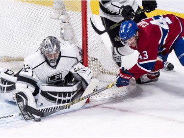 Los Angeles Kings' goalie Jonathan Quick (32) stops Montreal Canadiens' Daniel Carr (43) as he tries to score on the wrap around during second period NHL hockey action, in Montreal, on Thursday, Dec. 17, 2015.