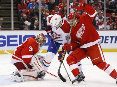 Red Wings goalie Petr Mrazek stops a shot as Canadiens' Lars Eller tries for a rebound as Red Wings defenceman Alexei Marchenko, right, defends in the third period of an NHL hockey game Thursday, Dec. 10, 2015 in Detroit.