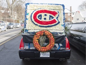 A floral arrangement with the Montreal Canadiens' logo is shown on a hearse as it arrives for the funeral of Montreal Canadiens' hockey legend Dickie Moore, in Montreal, on Monday, Dec. 28, 2015. Moore passed away on December 19.