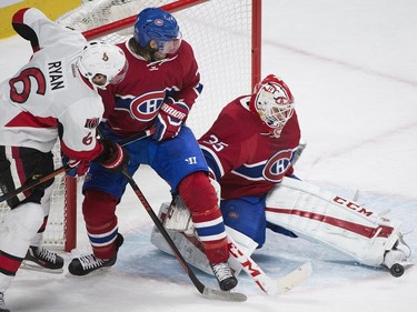 Montreal Canadiens' goalie Dustin Tokarski makes a save as Ottawa Senators' Bobby Ryan (6) and Canadiens' Tom Gilbert look for the rebound during second period NHL hockey action, in Montreal, on Saturday, Dec. 12, 2015.