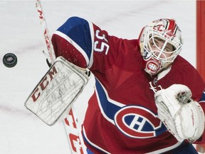 Montreal Canadiens' goaltender Dustin Tokarski makes a save against the Ottawa Senators during first period NHL hockey action, in Montreal, on Saturday, Dec. 12, 2015.