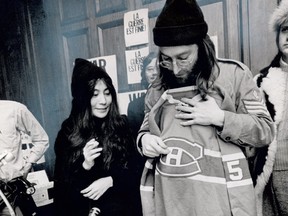 John Lennon is seen here holding up Gilles Tremblay's No. 5 Montreal Canadiens sweater during a peace conference at the Chateau Champlain in Montreal in December 1969.