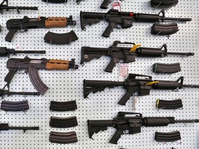In this July 20, 2014, file photo, guns are displayed for sale at Dragonman's, an arms seller east of Colorado Springs, Colo.