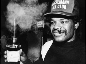 This Oct. 16, 1986, file photo shows Boston Red Sox centre fielder Dave Henderson during a locker room celebration after the Red Sox defeated the California Angels in the final game of the AL championship series in Boston, Mass. Henderson, who hit one of the most famous home runs in postseason history, died Sunday, Dec. 27, 2015, after suffering a massive heart attack. He was 57.