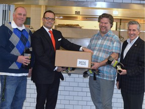 From left: Christopher Quinn, director of support services, Old Brewery Mission; Michael D. Penner, president and CEO, Peds Legwear; David Ferguson, chef/owner, Restaurant Gus; Matthew Pearce, president and CEO, Old Brewery Mission. The Socks for Bubbly campaign, organized by Ferguson, led to the collection of nearly 20,000 pairs of socks for the homeless.