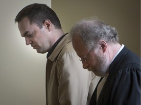 Guy Turcotte, left, followed by one of his lawyers, Pierre Poupart, enters the St. Jerome courtroom to hear his verdict. The former cardiologist was charged with first-degree murder for stabbing his two young children to death in 2009. Turcotte was found guilty of second-degree murder by a jury on Sunday, Dec. 6, 2015.