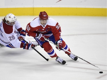 Montreal Canadiens defenseman Jeff Petry (26) tries to stop Washington Capitals center Evgeny Kuznetsov (92), of Russia, during the third period of an NHL hockey game, Saturday, Dec. 26, 2015, in Washington. The Capitals won 3-1.