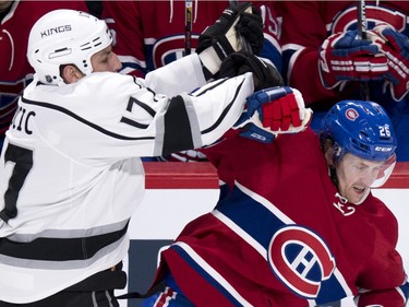 Canadiens' Jeff Petry  fends off Kings' Milan Lucic during first period NHL hockey action, in Montreal, on Thursday, Dec. 17, 2015.
