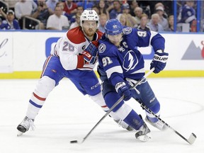 Tampa Bay Lightning centre Steven Stamkos (91) works around Montreal Canadiens defenceman Jeff Petry (26) during the second period of Game 6 of a second-round NHL Stanley Cup hockey playoff series Tuesday, May 12, 2015, in Tampa, Fla.