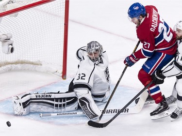 Los Angeles Kings' goalie Jonathan Quick (32) makes a kick save off Montreal Canadiens' Alex Galchenyuk (27) as he is covered by Los Angeles Kings' Andy Andreoff (15) during third period NHL hockey action, in Montreal, on Thursday, Dec. 17, 2015. Quick shut out the Canadiens 3-0.