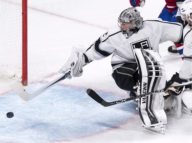 Los Angeles Kings' goalie Jonathan Quick reaches back to stop a loose puck as they face the Montreal Canadiens during third period NHL hockey action, in Montreal, on Thursday, Dec. 17, 2015. Quick shut out the Canadians 3-0.