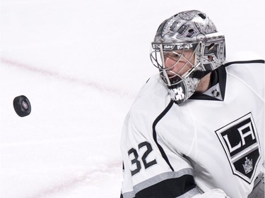 Los Angeles Kings' goalie Jonathan Quick looks back at the puck after defecting a shot as they face the Montreal Canadiens during third period NHL hockey action, in Montreal, on Thursday, Dec. 17, 2015. Quick shut out the Canadiens 3-0.