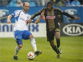 Montreal Impact's Justin Mapp, left, battles for the ball against Philadelphia Union's Raymon Gaddis during second half MLS soccer action in Montreal, Saturday, April 26, 2014.