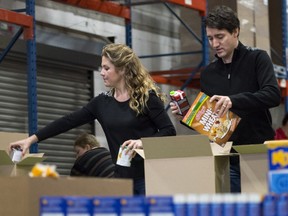 Prime Minister Justin Trudeau and his wife Sophie prepare Christmas baskets with volunteers at Moisson Montreal, a food bank, Friday, December 18, 2015 in Montreal.