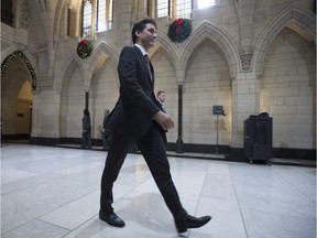 Prime Minister Justin Trudeau makes his way through the Hall of Honour to party caucus Wednesday, Dec. 9, 2015, in Ottawa.